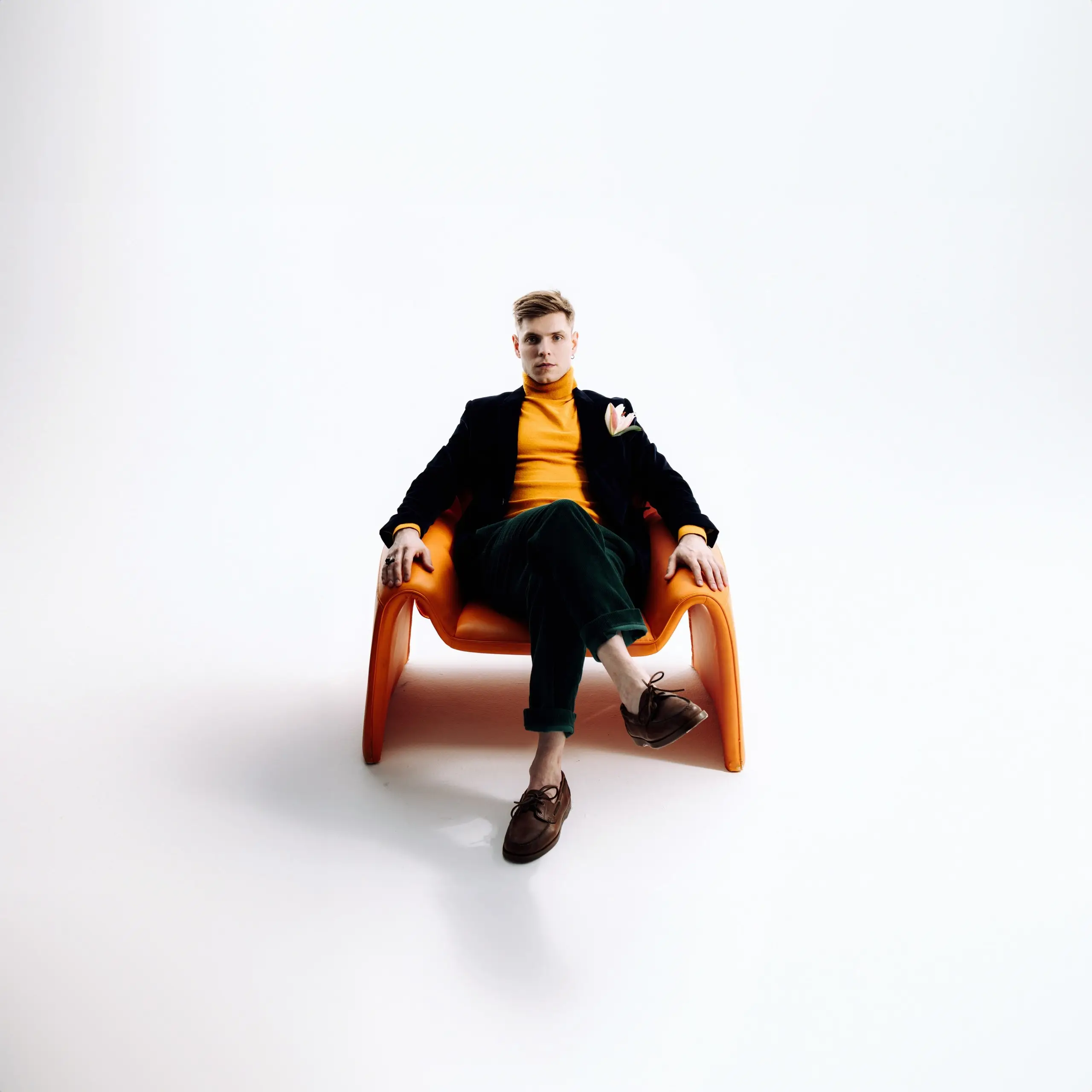 Viktor Tarakanov seated in an orange chair
